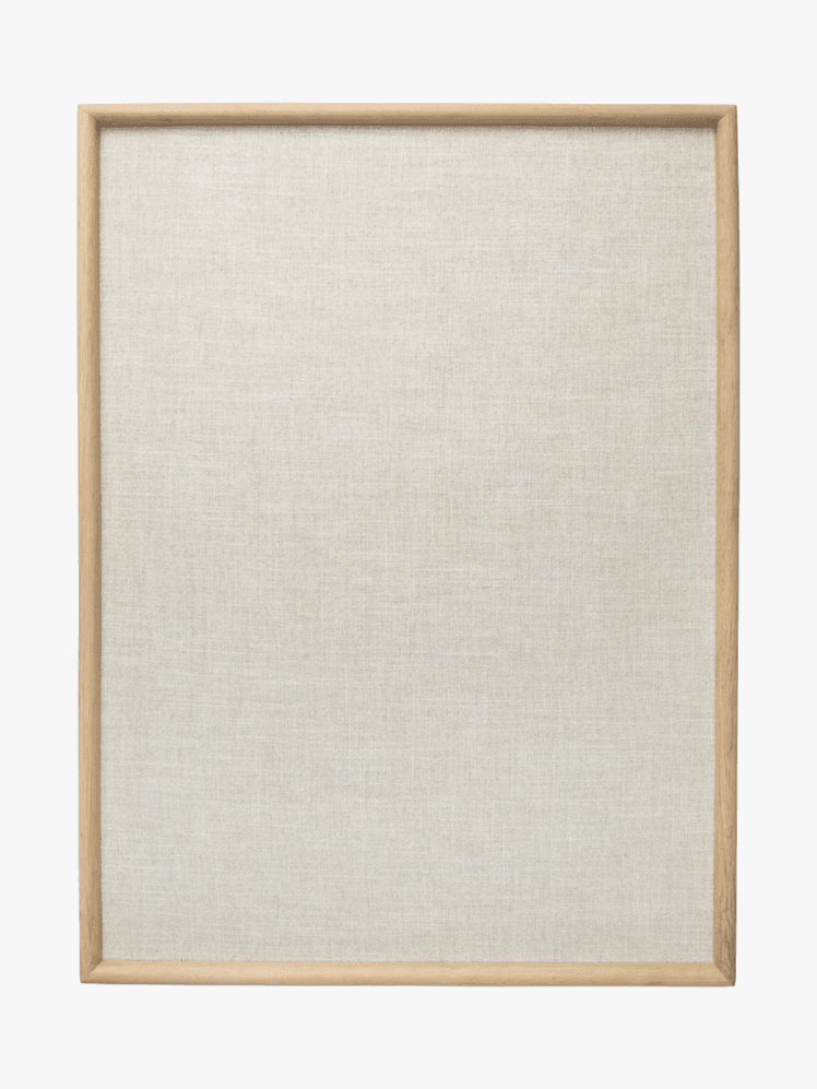 A linen memo board with oak border